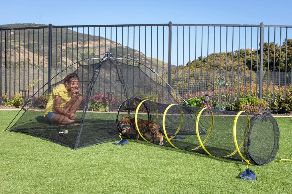 Portable cat enclosure set up in a garden.